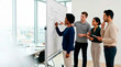 © Xenia - Diverse business team brainstorming around a whiteboard in a modern office. Professionals collaborating and planning strategy with flowcharts