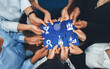 © InfiniteFlow - Diverse corporate officer workers collaborate in office, connecting puzzle pieces to represent partnership and teamwork. Unity and synergy in business concept by merging jigsaw puzzle. Concord Amity