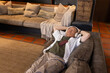 © Wavebreak Media - Senior Asian man lying on chaise in lounge wearing headphones, phone resting on chest, copy space