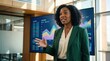 © ryker - Confident African American businesswoman giving presentation in modern office with colorful charts and graphs on large screens, professional attire and engaged expression
