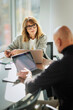 © gzorgz - Group of business people having business meeting in a bright conference room