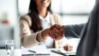 © Mary - Close-up of professional handshake across office desk during meeting, representing agreement and successful partnership.
