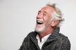 © Markus Schröder - Portrait of a jovial caucasian man in his 60s laughing in front of white background