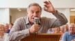 © Tatyana - Elderly man calling bingo with microphone and ball at community hall