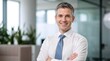 © Vasiliy - Professional portrait of smiling executive in white shirt and tie. Confident middle aged businessman in modern office. Corporate leadership and success concept