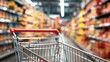 © The Little Hut - Empty Shopping Cart on Blurred Supermarket Aisle with Shelves Full of Products