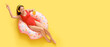 © Pixel-Shot - Beautiful Asian woman in swimsuit drinking cocktail and listening to music while relaxing on inflatable ring against yellow background with space for text, top view
