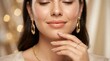 © Gophotograph - Elegant woman with flawless skin wearing gold jewelry, earrings, ring, and necklace.