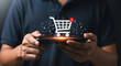 © Nasima88 - Online shopping concept with man holding smartphone and virtual shopping cart
