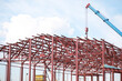 © alexkich - Industrial Construction Site with Steel Frame Building and Crane in Progress