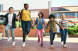 © peopleimages.com - Happy, children and holding hands at school with walk, bonding together and education for growth. Students, friends and skipping at recess with diversity, wellness and learning for skill development.