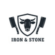 © ainun - Iron & Stone Butcher Logo With Cow Head, Cleavers and Shield for Steakhouse Branding.