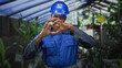 © Krakenimages.com - Man construction worker in blue hardhat forms heart with hands gesture inside a building, smiling broadly; pride teamwork.