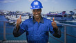 © Krakenimages.com - Man construction worker in blue coveralls and hardhat pointing fingers down at railing building; pride.