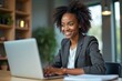© Vera - Confident African American Woman Accountant Manager Displays Professionalism and Focus While Working on Laptop in Office
