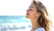 © Andri - Young woman with eyes closed breathing deeply on a sunny beach, serene expression, soft ocean waves and bright sky in background, feeling peaceful