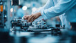 © KotBaton - Close-up of engineer hands adjusting precision industrial machinery in modern factory, manufacturing automation and high technology production concept.