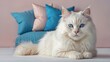 © poomrapee - Celestial Gaze: A stunning long-haired cat, its mesmerizing blue eyes sparkle with a serene expression, rests gracefully atop a pile of plush pillows, inviting you into its world of tranquil beauty.
