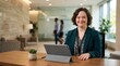© spyrakot - Receptionist with Down Syndrome Smiling at Front Desk in Modern Office