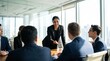 © ryker - Confident South Asian businesswoman leading meeting in bright modern conference room, engaging colleagues with friendly gesture and professional presence