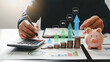 © picbox - Interest rate and dividend concept, Businessman is calculating income and return on investment in percentage. income, return, retirement, compensation fund, investment, dividend tax, stock market