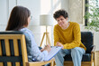 © Valerii Honcharuk - Happy teenage boy smiling during successful consultation with female psychologist