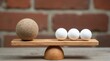© Alex Pios - Wooden scale with one large textured ball and four small white balls. Objects rest on plank surface, brick wall background. Concept of choice decision or unfairness.
