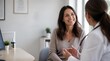 © Diego - Smiling woman consulting with female doctor about health