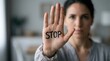© Masque - Closeup of a woman's hand with the word STOP written on it to reject harassment and set boundaries.