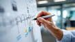 © Nataliya - Close-up of a hand drawing a quarterly timeline on a whiteboard with progress icons and milestone markers, visual planning concept, business goal mapping, project roadmap session,
