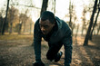 © Davor - Focused male athlete training on forest trail at sunrise