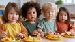 © AZ Studio - Diverse toddlers enjoying healthy snacks together at a daycare table