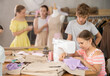 © JackF - Girl sews on a sewing machine. A boy watches and learns