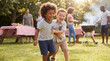 © Morrina - Summer outdoor toddler boys playing laughing together at barbecue party for joyful childhood friendship celebration lifestyle photography