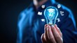 © Arnab Dey - Businessman holding AI light bulb with graduation cap icon, representing artificial intelligence in education, smart learning systems, online courses, digital transformation and e-learning technology.