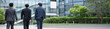 © kapinon - 都会のビル背景で横並びで歩くハンサムな営業チーム、法人営業や企業成長など若手から管理職のポジティブイメージ顔無しの後ろ姿のバナー
