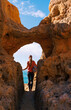 © M.studio - adventurous woman discovering a secret coastal passage in algar seco