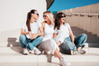 © halayalex - Three young beautiful smiling hipster female in trendy summer white t-shirt  and jeans clothes. Sexy carefree women posing in street. Positive models having fun, going crazy. In sunny day