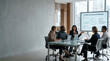 © Abay - Diverse corporate team discussing Ethical AI and data governance in modern office boardroom meeting