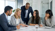 © ark - Diverse group of professionals collaborating around a conference table, discussing documents and sharing ideas in a modern office setting