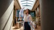 © Agus Through Lens - Elegant woman in a luxury boutique using augmented reality to visualize floating fabrics