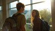 © wirachut - Back to school first day excitement shows in happy faces of two students with backpacks chatting near large window with sunlight shining through