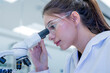 © Hip.hub - Scientist looks through microscope in laboratory during work hours