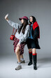 © wedmoments.stock - Two stylish women taking a selfie on smartphone, isolated background. Concept friendship, social media lifestyle and modern communication.