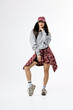 © wedmoments.stock - Young woman in trendy retro-inspired outfit posing on isolated background. Concept youth fashion, individuality and modern style.