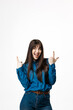 © wedmoments.stock - Female model gesturing upward with fingers in studio on white backdrop. Concept direction, information and advertising banner.