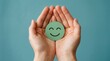 © Pinit - A green happy smiley face held in hands for mental health assessment and child wellness.