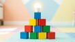 © Angga - Building Blocks of Innovation - Light Bulb Idea on Stacked Cubes.
