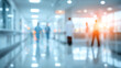 © Subin - Blurred view of a hospital corridor with healthcare professionals walking, conveying a sense of urgency and care.