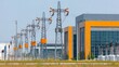 © shobakhul - High voltage power lines stretch away from a modern electrical substation building.